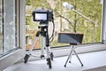 Camera and smartphone on tripods in front of an open window. Time lapse photography - smartphone vs camera