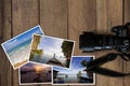 Camera and stack of photos on grunge wooden background