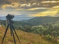 Camera and stand take time lapse on top of mountain and light ray Royalty Free Stock Photo