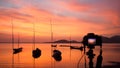 Camera standing on tripod at sunset at the sea in Thailand; land Royalty Free Stock Photo