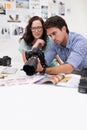 Camera, studio and photographers team editor in an office or workshop for production. Creative, photography and young