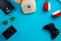 Camera, sunglasses, VHS videotape. Rotary phone, red white headphones, video game joystick on blue background with copy Royalty Free Stock Photo