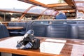Camera on table by interior seating inside a glass roofed sightseeing canal cruise trip boat for tourists