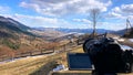 The camera takes a view of the mountains timelapse over the forest on a tripod.