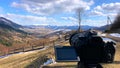 The camera takes a view of the mountains timelapse over the forest on a tripod.