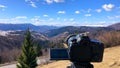 The camera takes a view of the mountains timelapse over the forest on a tripod.