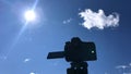 The camera takes a view of the mountains timelapse over the forest on a tripod.