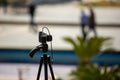 A camera taking pictures on a tripod Royalty Free Stock Photo
