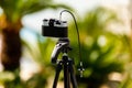 A camera taking pictures on a tripod Royalty Free Stock Photo