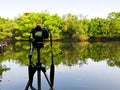 Camera on tripod at lake side Royalty Free Stock Photo