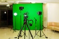The camera on the tripod, led floodlight, headphones and a directional microphone on a green background. The chroma key Royalty Free Stock Photo
