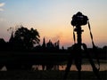 Camera tripod and ruin silhouette sunset sky Royalty Free Stock Photo