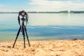 A camera on a tripod on the sandy beach
