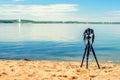 A camera on a tripod on sea background