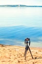 A camera on a tripod on sea background