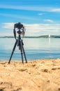 A camera on a tripod on sea background