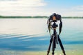 A camera on a tripod on sea background