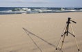 Camera tripod standing in the seasand. Royalty Free Stock Photo
