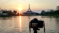 The camera is on a tripod, taking a photo of a pavilion sunset or evening time Ratchamangkhala Pavilion at public park name Suan