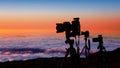 Camera tripods photographer sunset sea of clouds Royalty Free Stock Photo