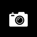 Camera vector icon isolated on black background.