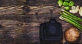 Camera and vegetables on wooden background, as a concept of food photography. Creative conceptual picture for professional dishes Royalty Free Stock Photo