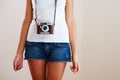 Camera, woman and closeup of a photographer in studio for travel, photography or creativity. Trendy casual fashion of a