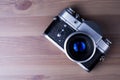 Camera on a wooden table, an old camera. Royalty Free Stock Photo