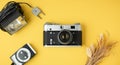 camera on the yellow background. Old gear for photography. Stylish background for a photo enthusiast. Flat lay Royalty Free Stock Photo