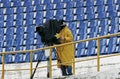 A cameraman filming a football game on a stadium Royalty Free Stock Photo