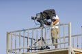 A cameraman filming a football game on a stadium Royalty Free Stock Photo
