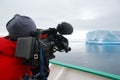 Cameraman filming a big blue iceberg Royalty Free Stock Photo