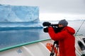 Cameraman filming a big iceberg Royalty Free Stock Photo