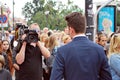 The cameraman filming outdoor event. TVP reporter Royalty Free Stock Photo