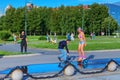 Cameraman makes a video of the girl riding on gyroscooter.