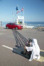 Cameraman shooting commercial for Audi automobile next to beach, Nice, France