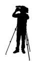 Cameraman  silhouette with video camera on event, concert, sport match,  isolated on background. Reporter . Royalty Free Stock Photo