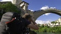 Cameraman waiting for a Bosnian diver to jump into the Neretva River from the Stari Most, old Mostar Bridgeof, Bosnia Royalty Free Stock Photo