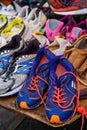 Used running sports shoes from various brands for sale at the market