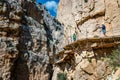 Visitors crossing the suspension bridge at Gaitanes Gorge, Malaga, Spain