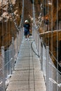 Visitors crossing the suspension bridge at Gaitanes Gorge, Malaga, Spain