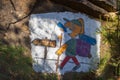 Camino de Santiago sign with drawing of unknown pilgrim. Pilgrimage concept. Funny pilgrim drawing image on rock.