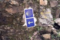 Camino de Santiago tiles on stone wall. Way of St. James signs