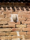 Camino route marker shell on a wall in Spain