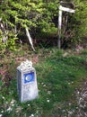 Camino trail marker with small stones on top from passing pilgrims.