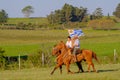 CAMINOS, CANELONES, URUGUAY, OCT 7, 2018: Gauchos riding horses and waving the Uruguayan flag at a Festival in Uruguay Royalty Free Stock Photo