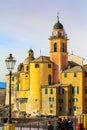 Camogli - People relaxing and the basilica Santa Maria Assunta in the background