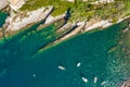 Camogli rocky coast aerial view. Boats and yachts moored near harbor with green water Royalty Free Stock Photo