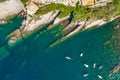 Camogli rocky coast aerial view. Boats and yachts moored near harbor with green water. Royalty Free Stock Photo