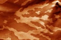 Camouflage cloth with blur effect in orange tone. Royalty Free Stock Photo